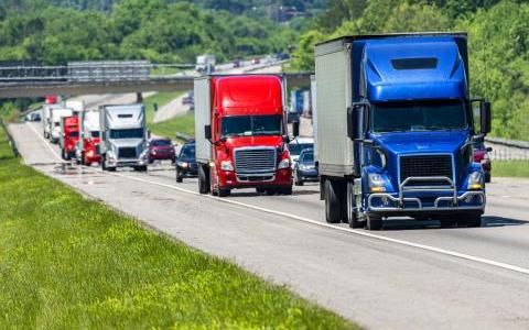 Semis climb a freeway hill